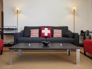 a living room with a couch and a coffee table at Apartment Les Combins 30 by Interhome in Champex