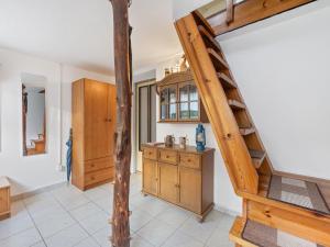 a kitchen with a spiral staircase in a house at Holiday Home Fish & Boat by Interhome in Hurka