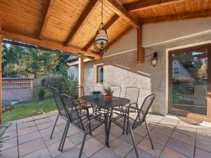 a patio with a table and chairs under a wooden ceiling at Holiday Home Fish & Boat by Interhome in Hurka