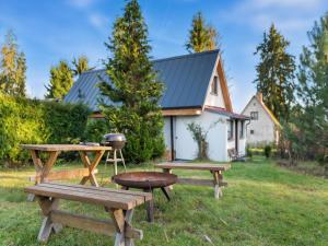 a picnic table and benches in front of a house at Holiday Home Fish & Boat by Interhome in Hurka