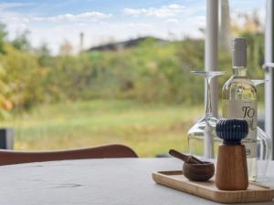 a bottle of wine sitting on a table next to a glass at Holiday Home Gun - 300m to the fjord by Interhome in Glostrup