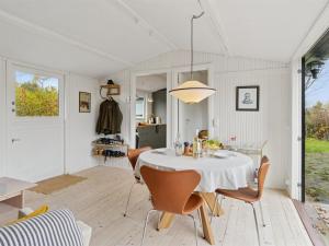 a dining room with a white table and chairs at Holiday Home Gun - 300m to the fjord by Interhome in Glostrup