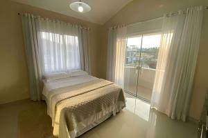 Ένα ή περισσότερα κρεβάτια σε δωμάτιο στο Great find on Garopaba Beach