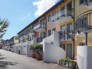 a row of apartment buildings with potted plants on the sidewalk at Apartment Residenz Marina-63 by Interhome in Bouveret