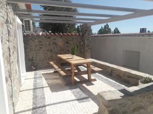 a picnic table on the patio of a house at Casas da Lameirancha in Mação
