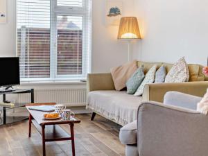 a living room with a couch and a table at 2 Bed in Bacton 75392 in Bacton