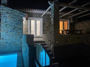 a room with a stone wall and a window at Casas da Lameirancha in Mação