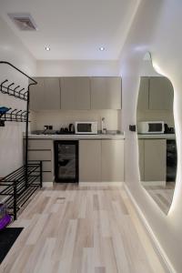 eine Küche mit weißen Schränken und einem Holzboden in der Unterkunft 402 Elegant Studio with Self Check-in Al-Salmaniyah Neighborhood in Riad