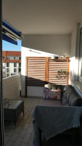 a living room with a couch and a table at Basti's Rooms&Breakfast - Self Checkin in Weil am Rhein