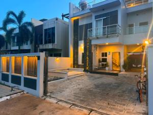 a house with a courtyard in front of it at Entire Villa, Ferry Terminal Pickup & Breakfast in Batam Center