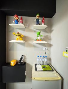 a wall with shelves with toy figurines on them at 逢甲Cartoon in Hsia-shih-pi