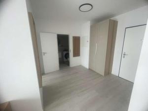 an empty room with white walls and a wooden floor at Apartmán P121 in Trnava
