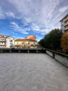 an empty parking lot with buildings in the background at Hermoso Housing Tortona in Tortona +25 photos