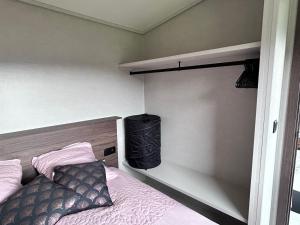a bedroom with a bed and a black bag at Chalet Tiny & Campagne in Onnion +10 photos