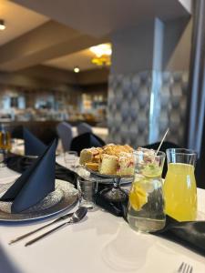 a table with a plate of food and drinks on it at NOVA Centrum Hotel in Radom
