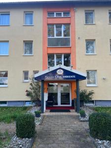 a building with a blue awning in front of it at Appartement am Löhner Bahnhof in Löhne +1 photo