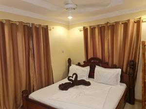 Un pat sau paturi într-o cameră la OH Zanzibar