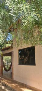 a building with a window and a tree at Canto da Árvore in Brasilia +5 photos