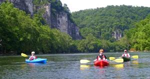 three people in kayaks on a river in the water at King Suite for a Cozy Romantic Getaway Overlooking the New River in Independence, Virginia in Independence