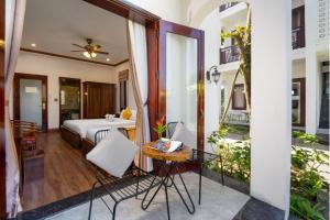 a bedroom with a bed and a table and a mirror at Villa Ban Hien in Hiếu Nhơn +45 photos