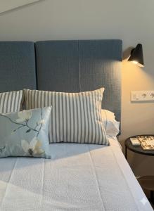 a bedroom with a bed with a pillow and a lamp at Castillo 22 in Oropesa