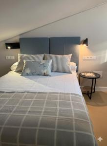 a bedroom with a large bed and a side table at Castillo 22 in Oropesa