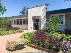 a building with a large rock in front of it at Resort Veldhoven in Veldhoven