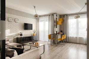 a living room with a couch and a table at Prestige Apartaments 79 in Wrocław