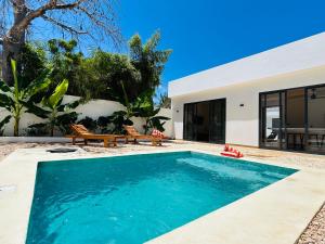 a swimming pool in the backyard of a house at U Paradisu Villas- 2 private pool villas in Kibigija