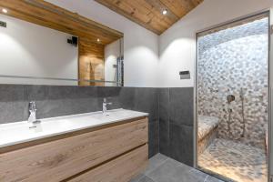 a bathroom with a sink and a shower at Penthouse Croix de Coeur in Riddes