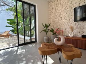 a living room with a table and a tv at U Paradisu Villas- 2 private pool villas in Kibigija