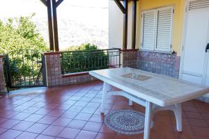 a white table on the balcony of a house at B&B VILLA BELLA in Catanzaro