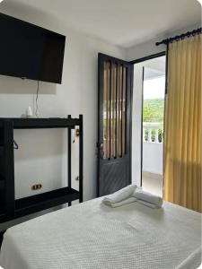 Ένα ή περισσότερα κρεβάτια σε δωμάτιο στο Apartahotel la Villa R&C