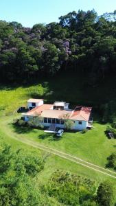 an aerial view of a house in a field at Pousada Quintal das Hortênsias in Salesópolis