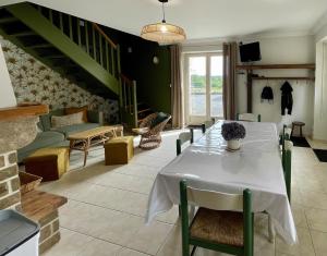 a living room with a table and a couch at AppartCosy 20 Maison proche "La Régalante" in Landavran