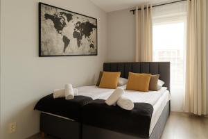 a bedroom with a large bed with two pillows at Prestige Apartaments 79 in Wrocław