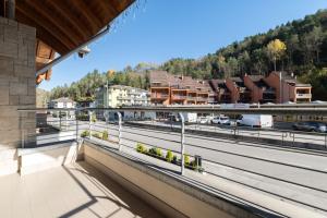 a balcony with a view of a train station at Appartamento Jubilant in Comano