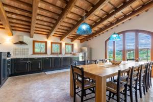 a kitchen and dining room with a wooden table and chairs at Villa Lucia in Barchi