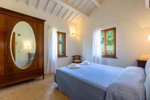 a bedroom with a bed and a large mirror at Villa Lucia in Barchi +22 photos