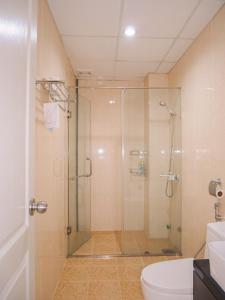 a bathroom with a glass shower and a toilet at 2BR Luxury riverview - Melody of the Sea Monarchy in Da Nang
