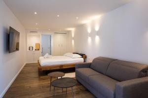 a living room with a couch and a bed at Suite Île du Levant - Jardin & Piscine - 4 pers in La Croix-Valmer