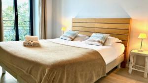 Ένα ή περισσότερα κρεβάτια σε δωμάτιο στο ApartHotel Riviera - Terrasse Felix Faure 2 - Massena