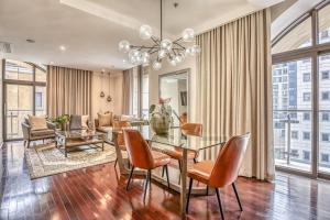 a dining room with a glass table and chairs at Micheal Angelo towers in Johannesburg