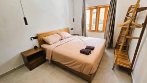 a small bedroom with a bed and a ladder at HomeVillas in Kuta Lombok +14 photos