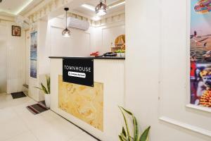 a restaurant with a counter with a sign on it at Super Townhouse Kali Ghat Prayagraj Formerly Ramesh Palace in Prayagraj