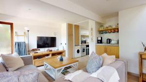 a living room with a couch and a table at San Lameer Serenity by Top Destinations Rentals in Southbroom