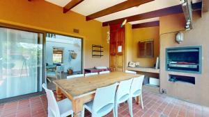 a dining room with a wooden table and white chairs at San Lameer Serenity by Top Destinations Rentals in Southbroom