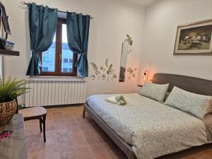 a bedroom with a bed and a window at Casa Gavì -Bike Friendly- in Buonconvento