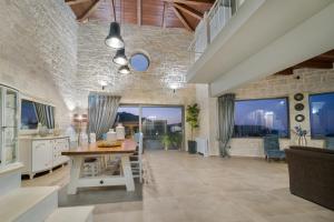 a kitchen and living room with a table and chairs at Petra Luxury Villa in Heraklio Town
