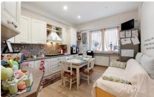 a kitchen with a table and a couch in a room at oparavisegenova in Genoa